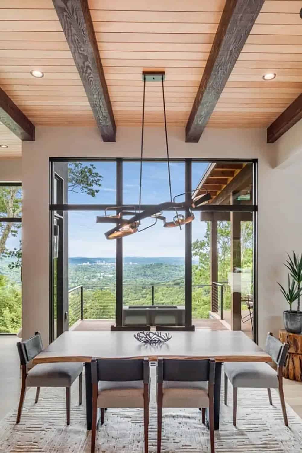 Dining room with sculptural chandelier and expansive valley views