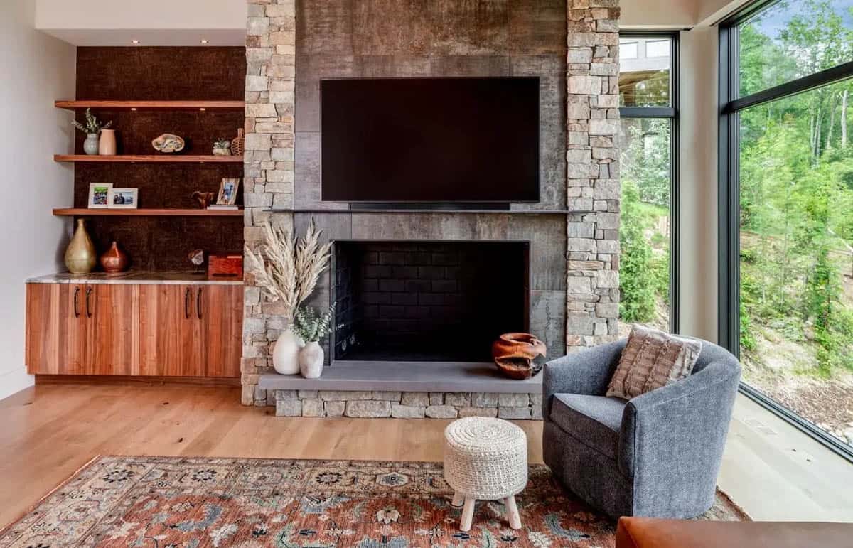 Living room fireplace wall with mounted television and stone cladding