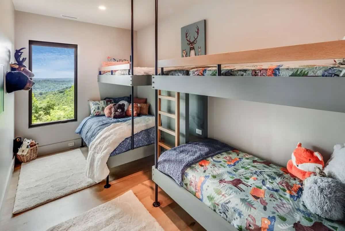 Kids bunk room with woodland themed bedding and mountain view