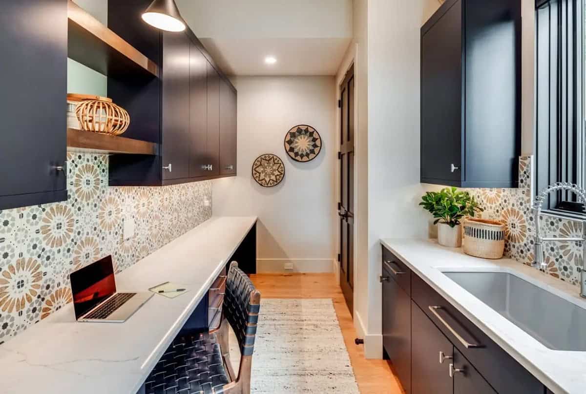 Mudroom desk nook with patterned tile backsplash and open shelving