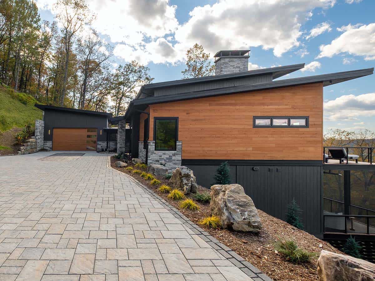 Cedar-clad side elevation with sloped black metal roofline