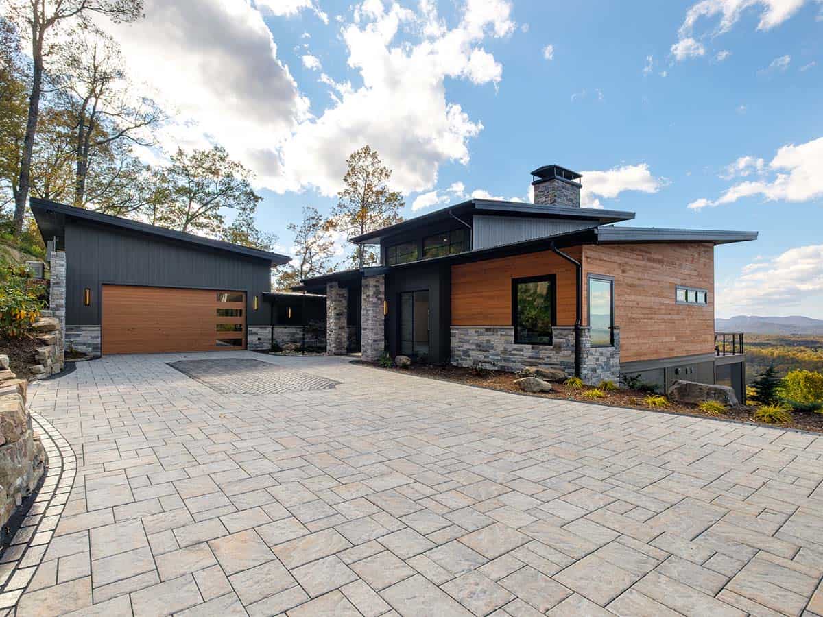 Wide exterior view showing garage wing and main living pavilion