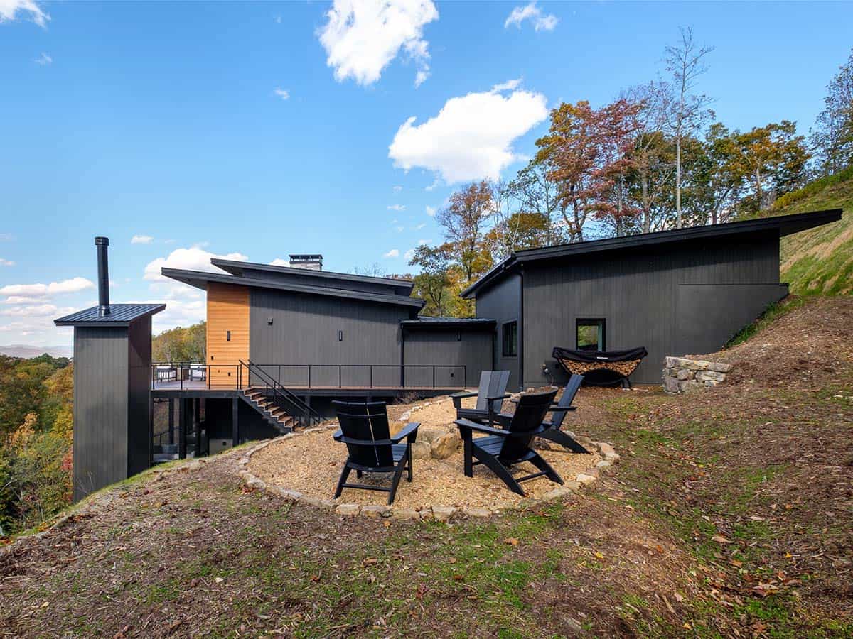 Rear deck and fire pit area against wooded hillside