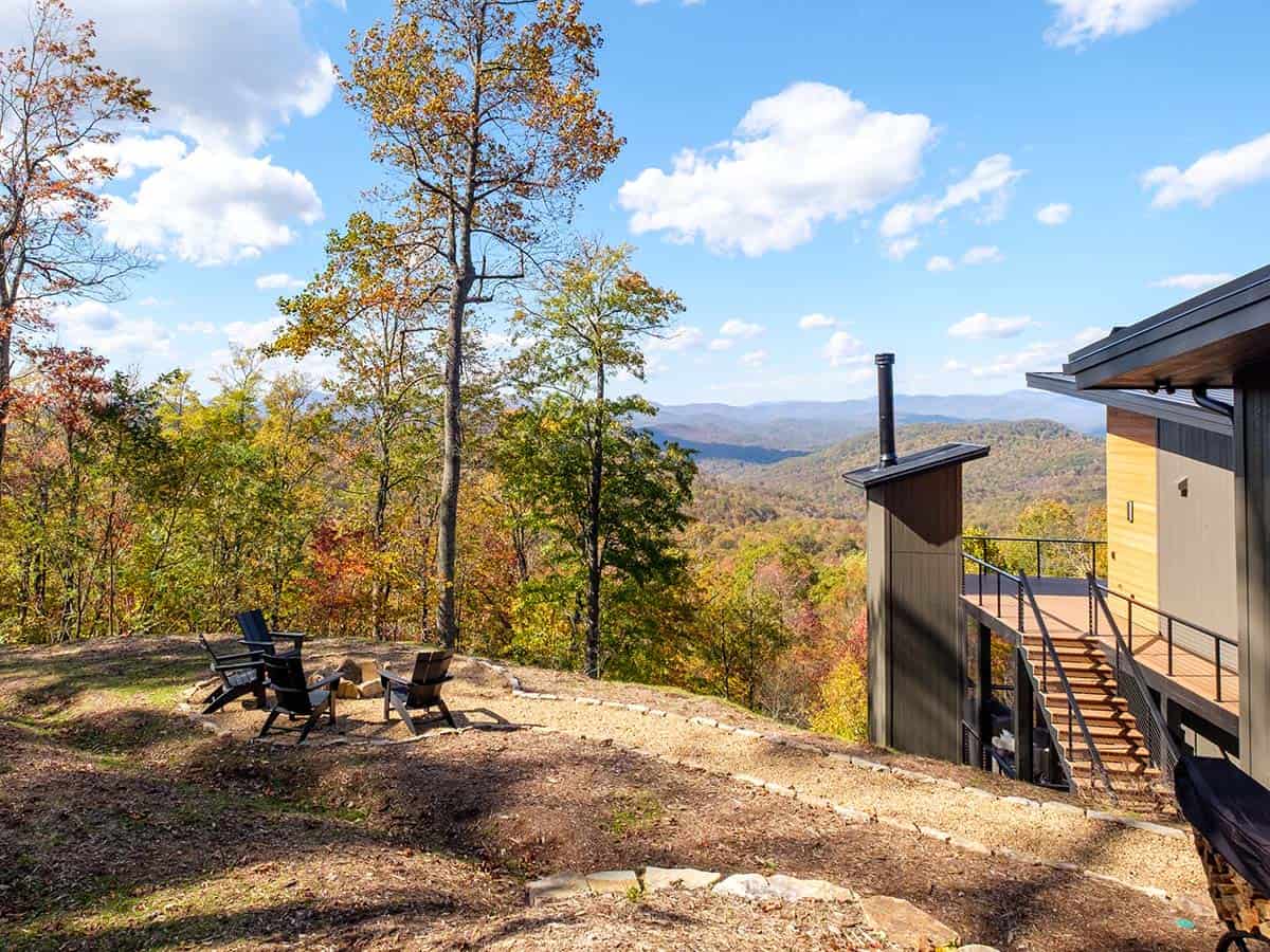 Mountain fire pit seating area overlooking layered autumn ridgelines