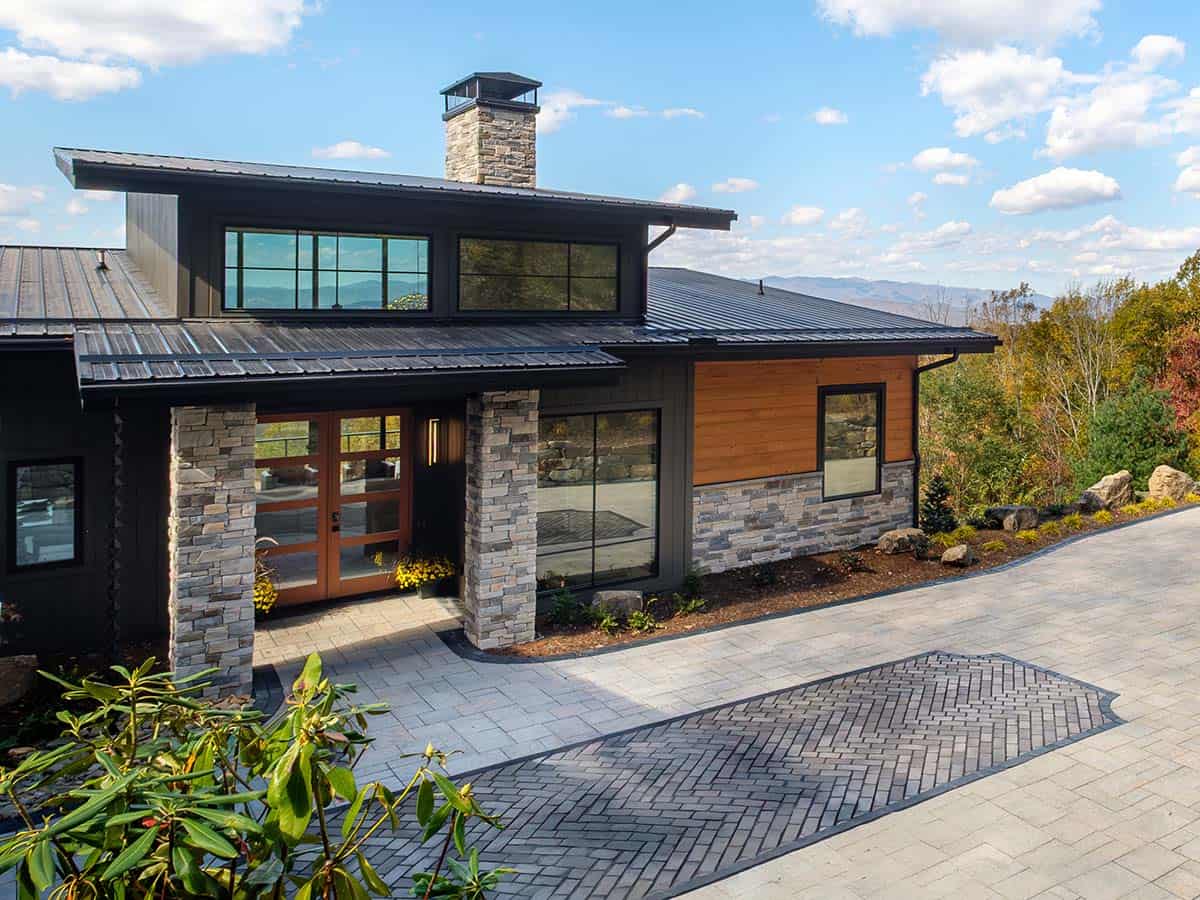 Angled facade with stone chimney and cedar accent wall