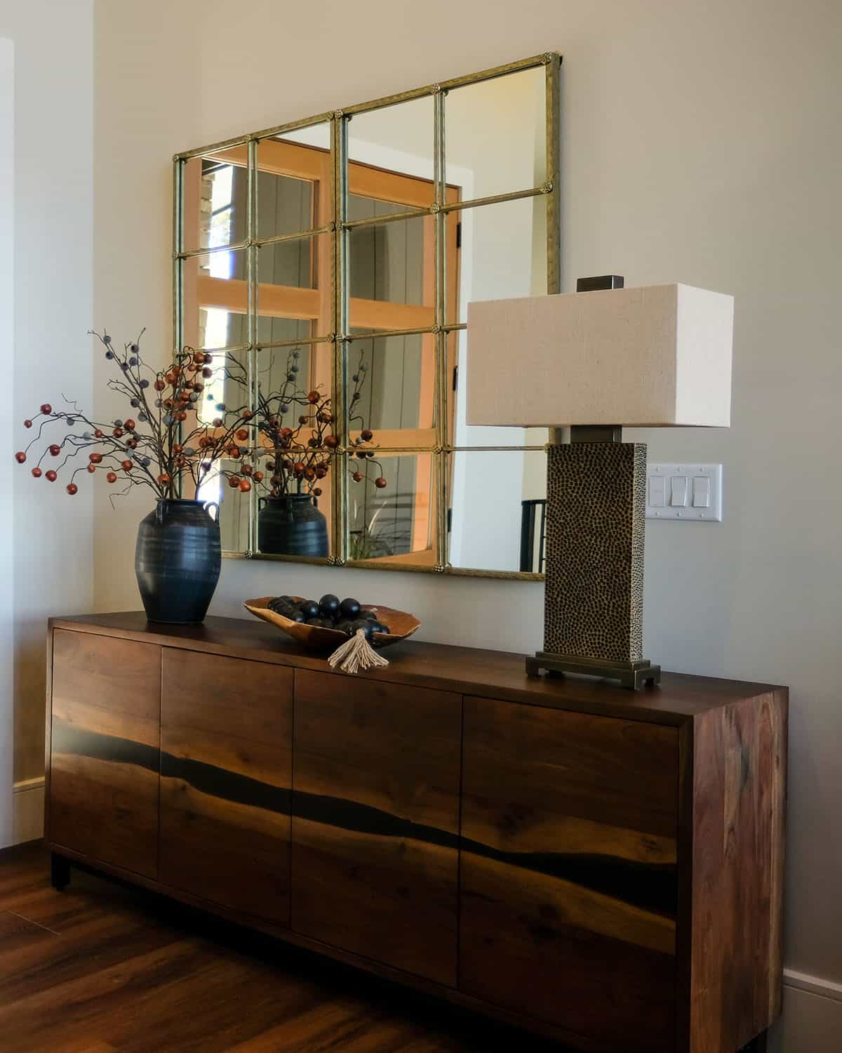 Entryway console with paneled mirror and hammered lamp base