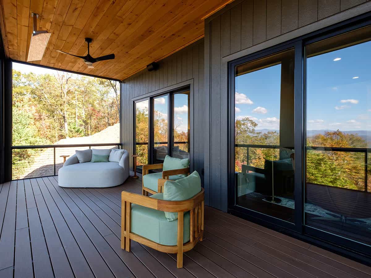 Screened porch lounge seating with mountain tree line view