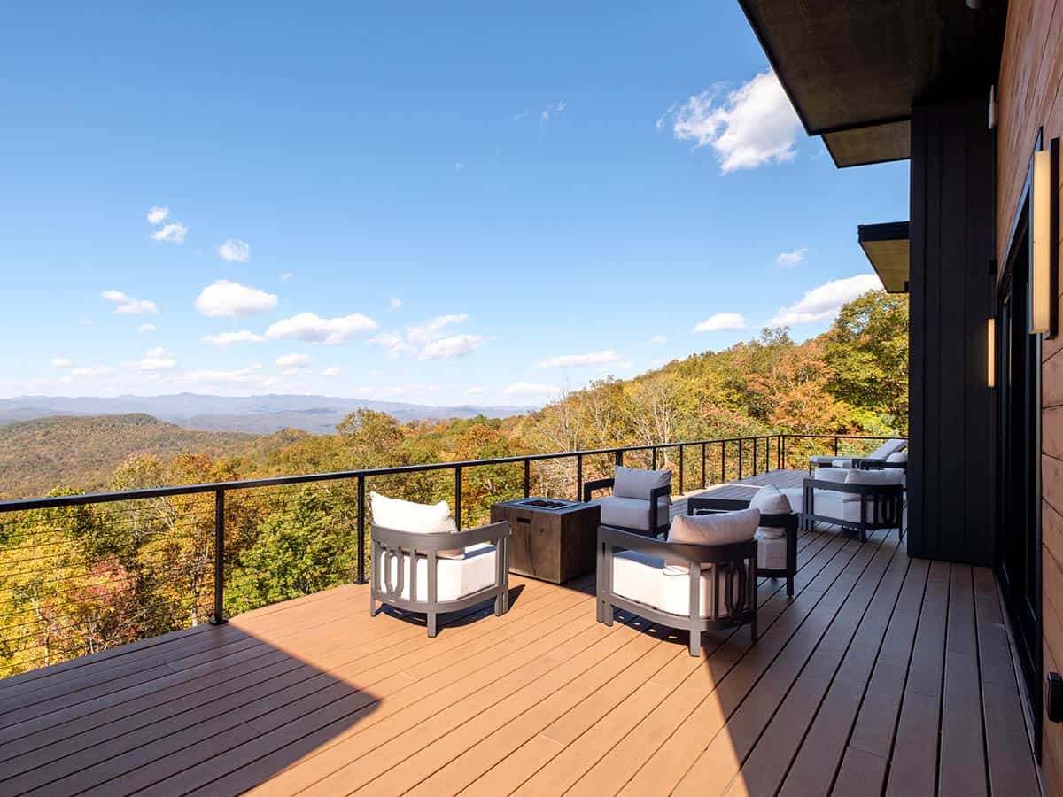 Elevated deck lounge chairs facing layered mountain ridgeline