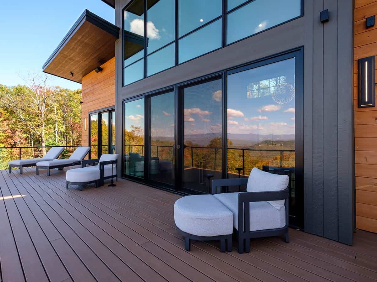Upper deck chaise lounges beside floor-to-ceiling glass doors