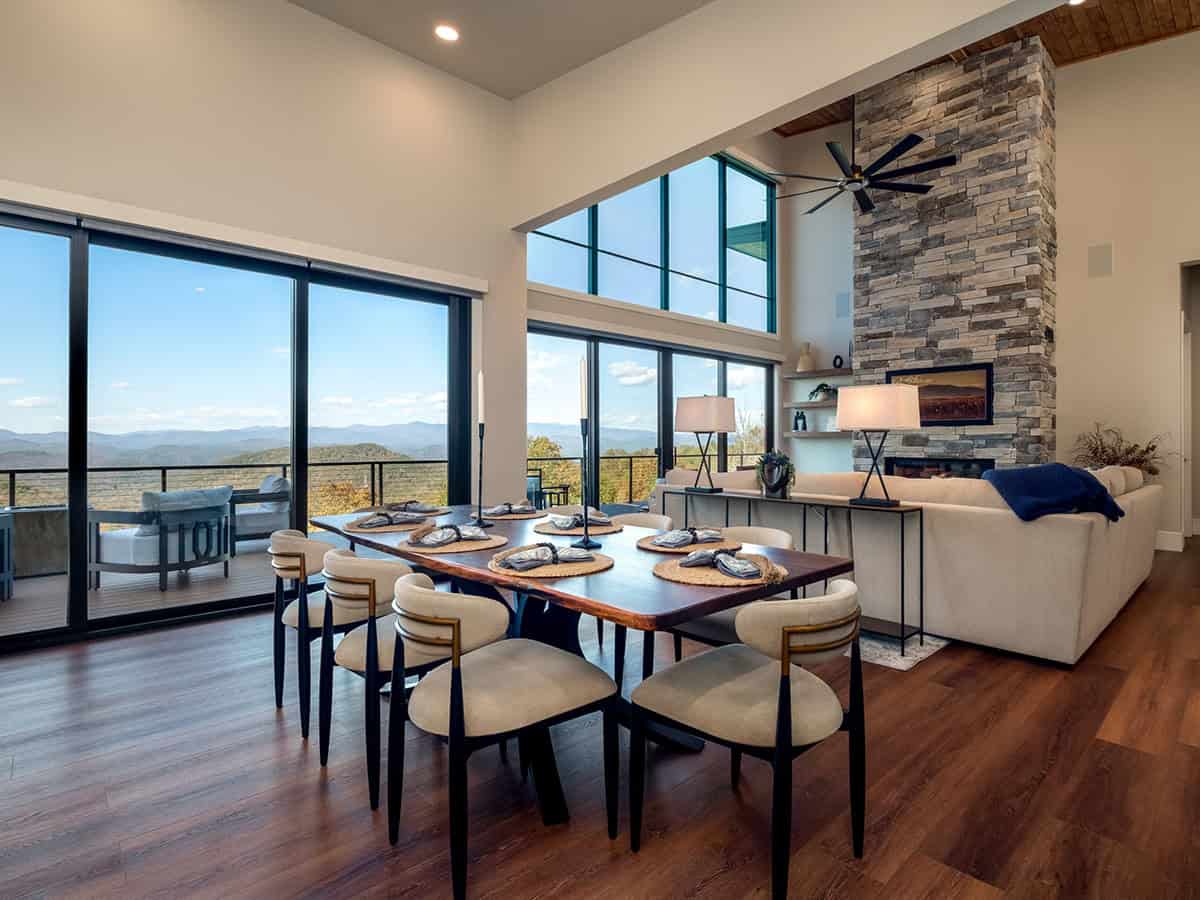 Open dining area with live-edge table and stone fireplace column