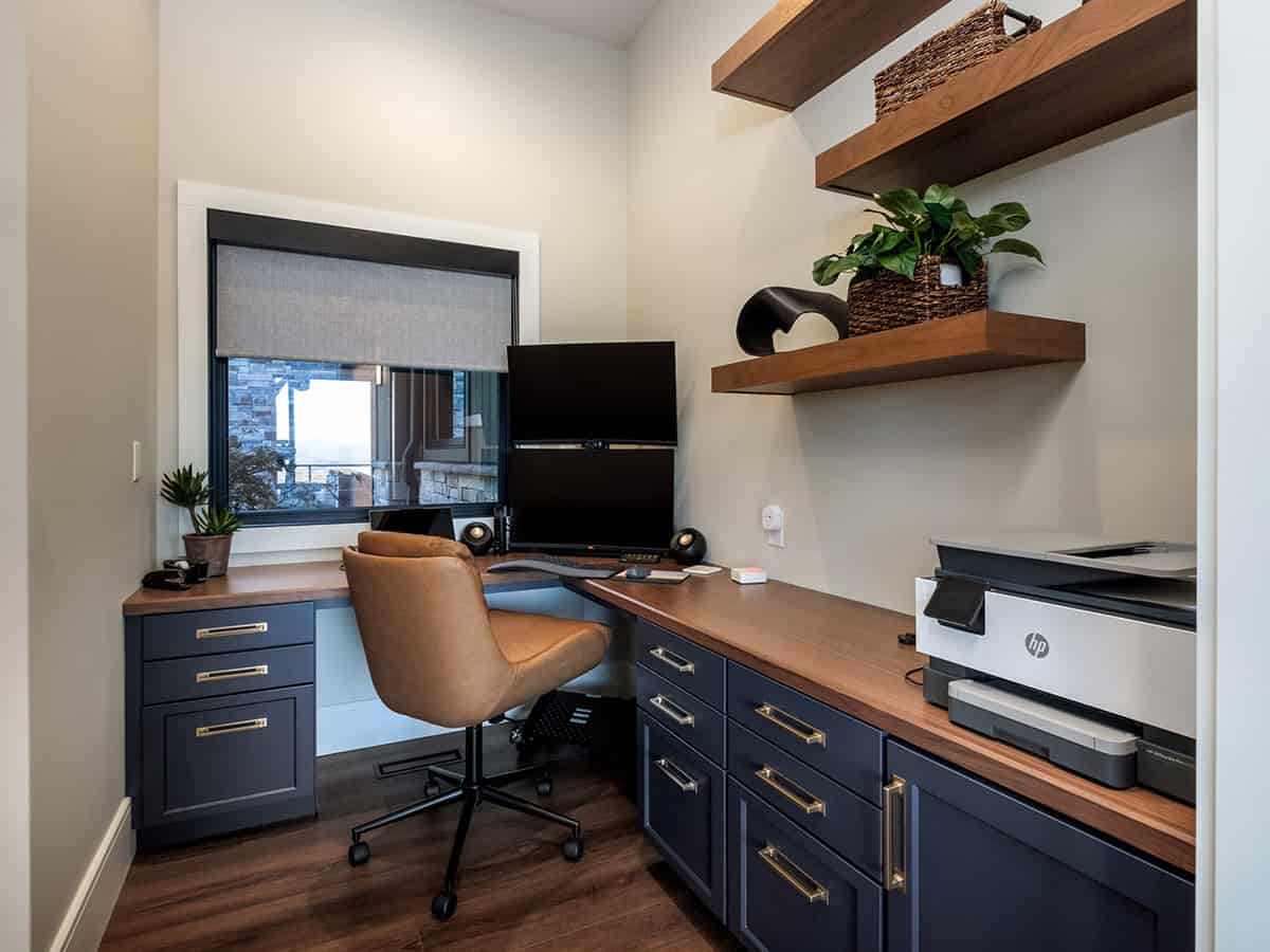 Home office nook with walnut desk and floating wood shelves
