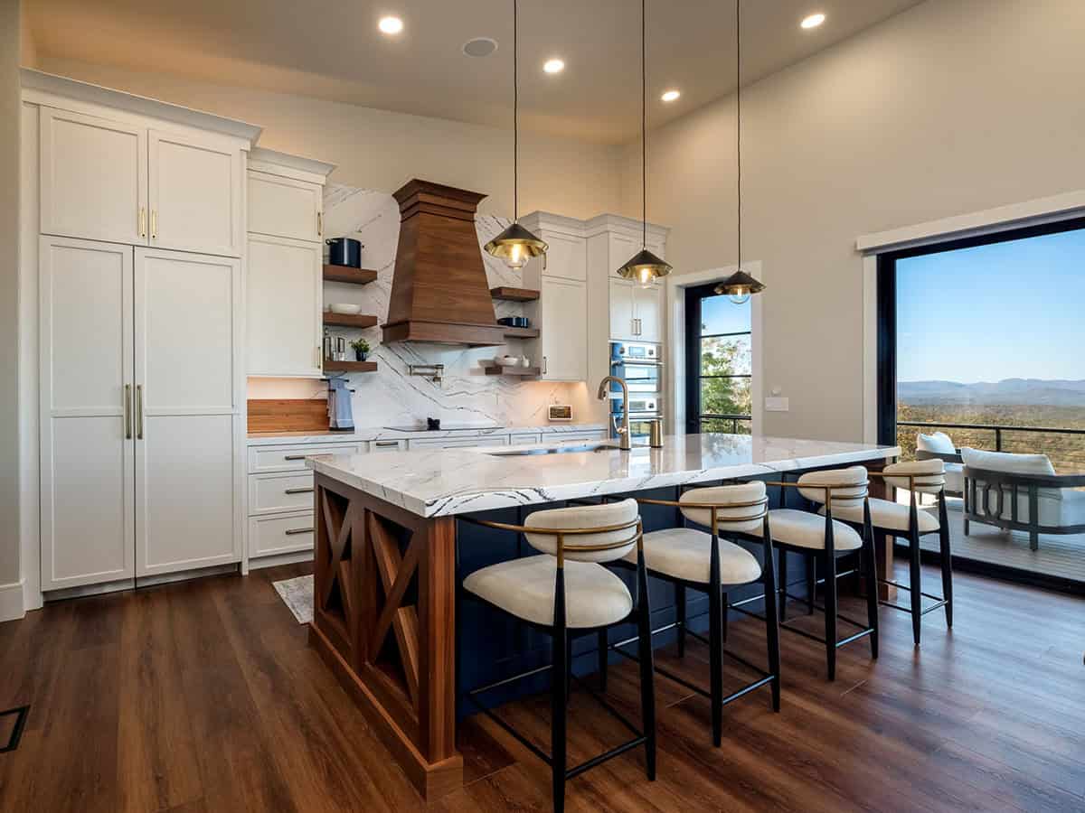 Kitchen island with waterfall countertop and mountain view beyond