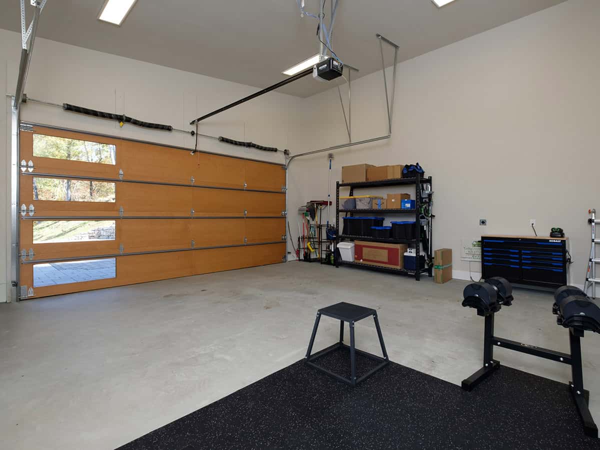 Home gym garage with weight rack and wood tool cabinet
