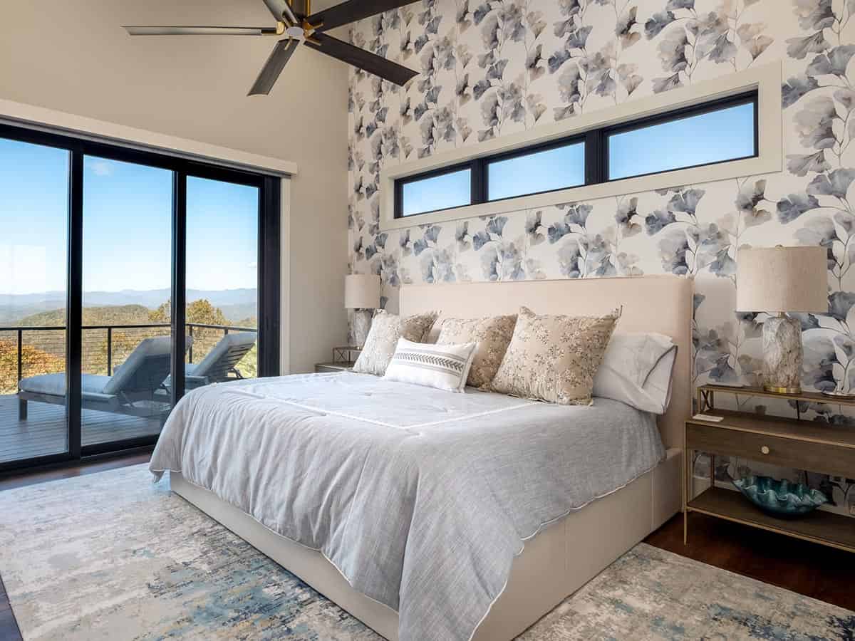 Bedroom with floral wallpaper and private deck access