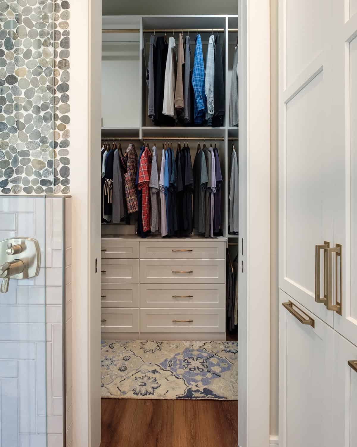 Walk-in closet with hanging storage and built-in drawers