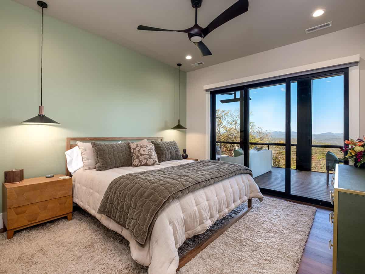 Primary bedroom with pendant lighting and private deck access