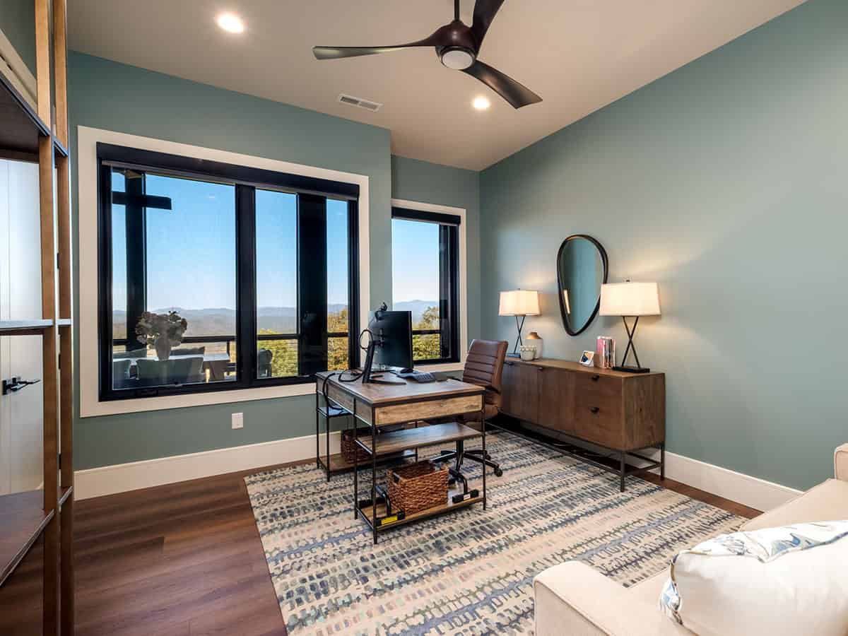 Home office with teal walls and mountain view windows