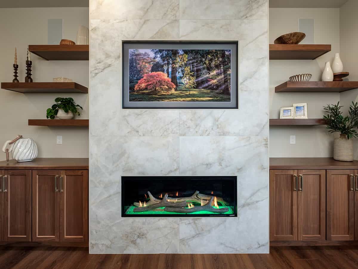 Marble fireplace wall flanked by walnut cabinets and shelving