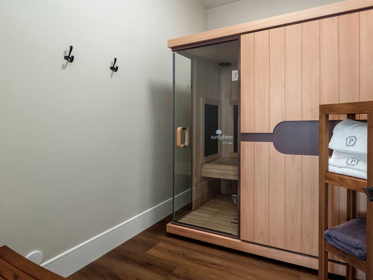 Infrared sauna with glass door and folded towel rack