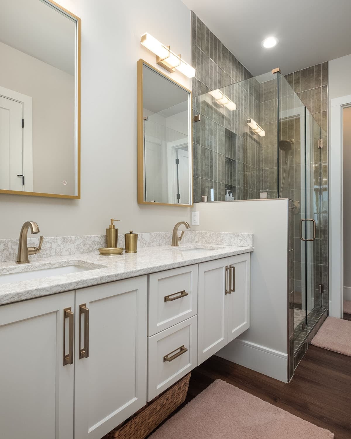 Ensuite vanity with glass shower and vertical tile wall