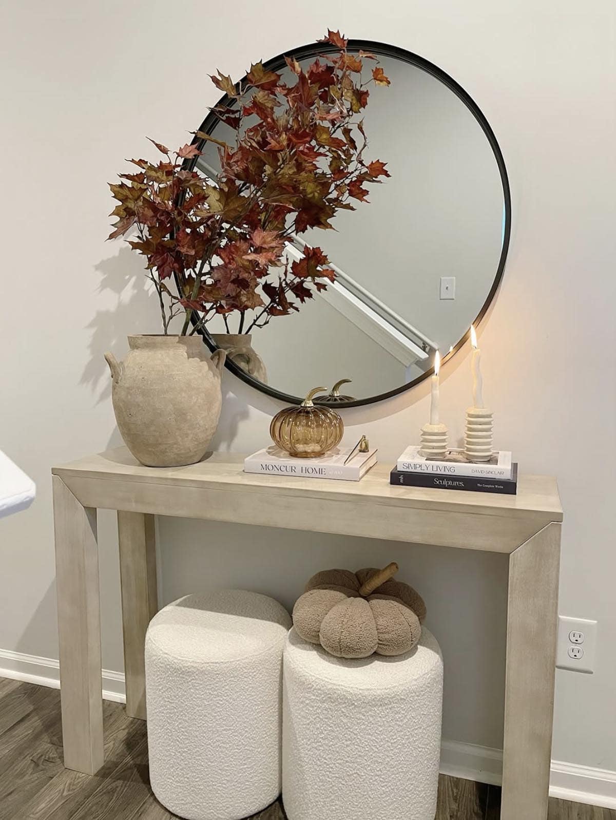 Neutral console table with taper candles, branches and a boucle pumpkin