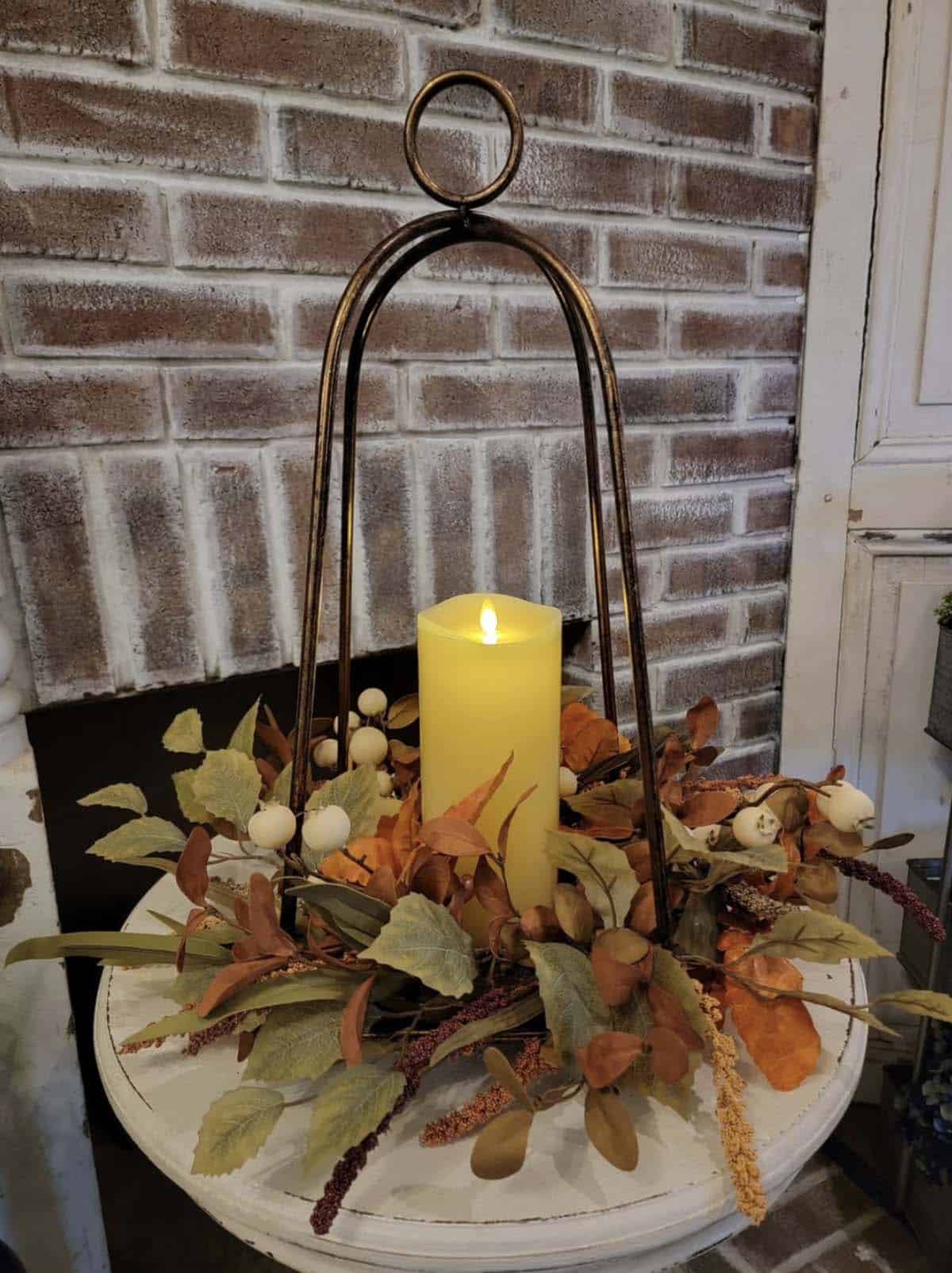 Metal lantern with a flameless candle and fall leaf ring