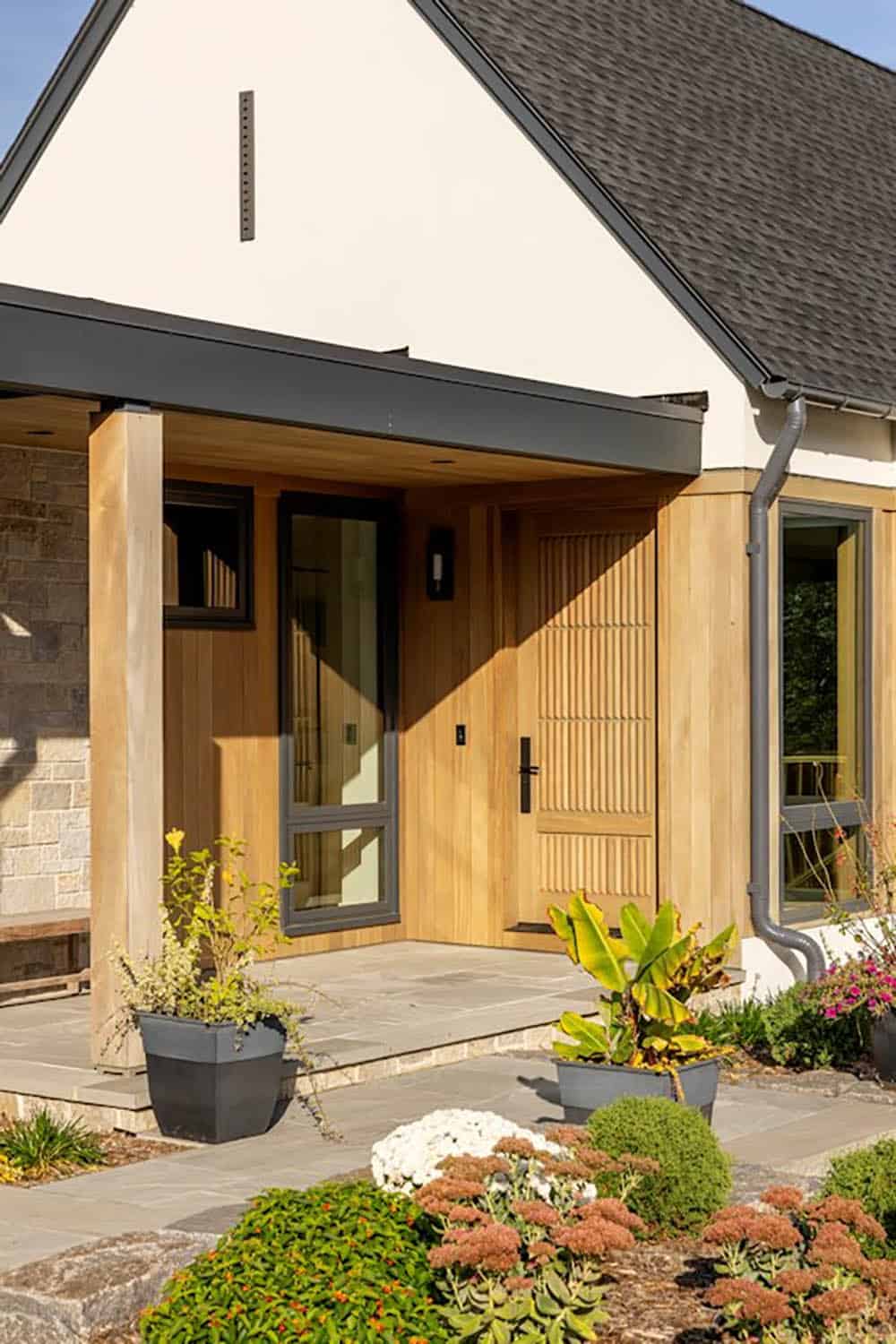 Cedar-clad entry with slatted wood door and black steel trim