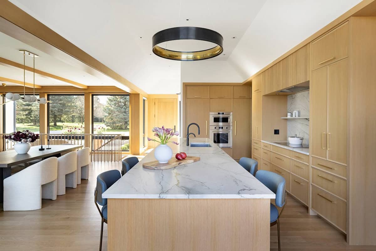 Kitchen island with marble counter and black ring pendant light
