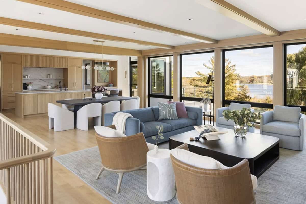 Living room and kitchen with lake views through large windows