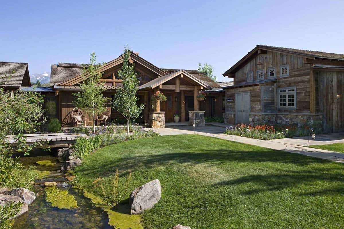 Reclaimed wood home entrance with stream and mountain backdrop