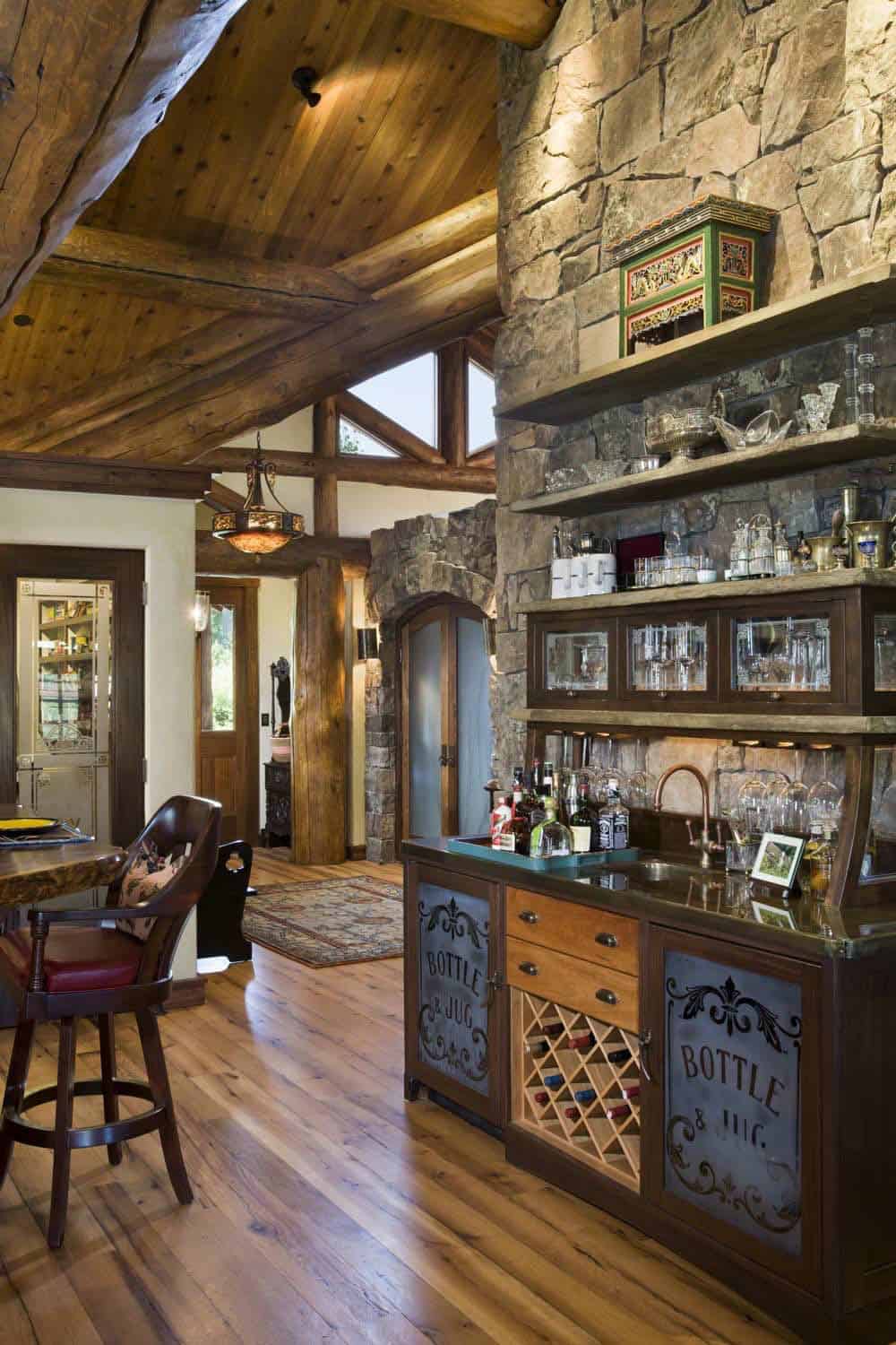 Stacked stone wet bar with vintage glass front cabinetry