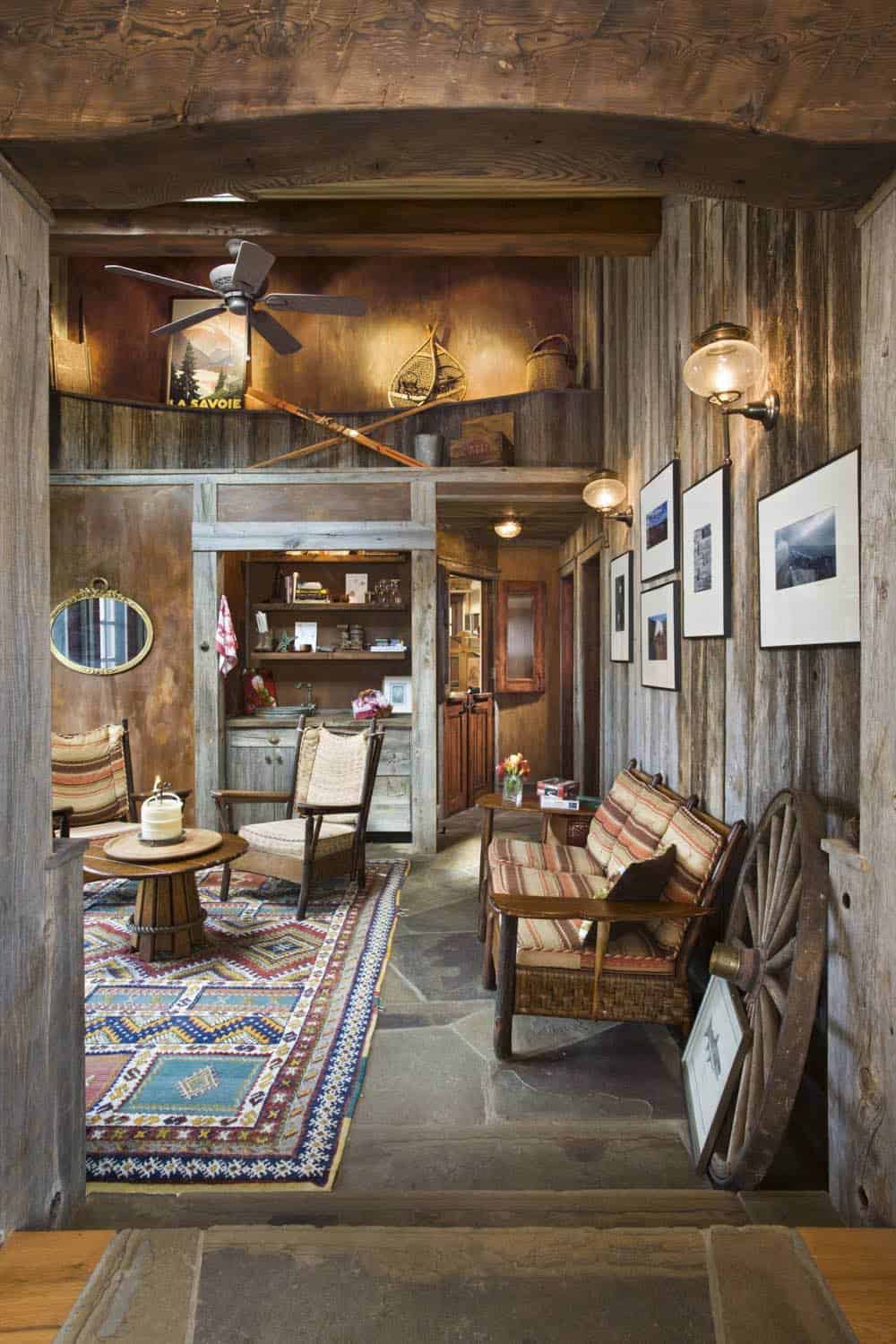 Bunkhouse lounge with reclaimed wood walls and patterned rug