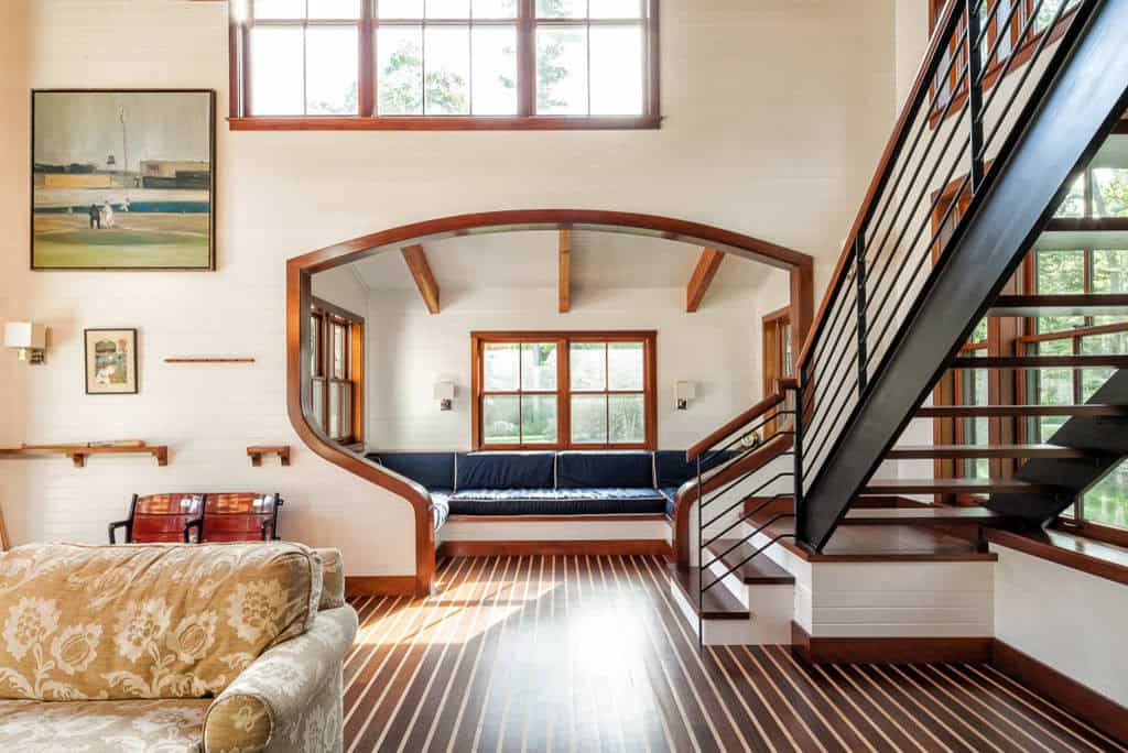 Living room view through the arch to the window seat and staircase