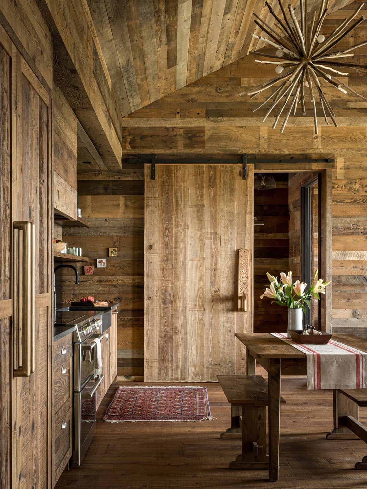 Rustic wood kitchen with sliding barn door and dining table