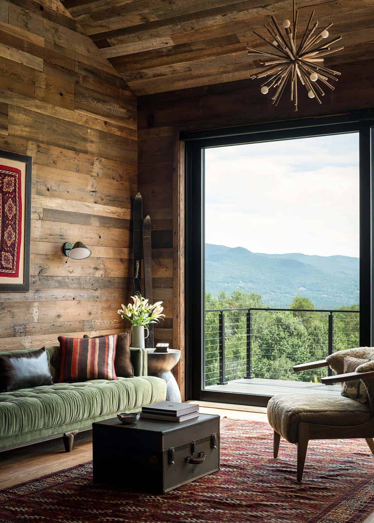Living room with green velvet sofa and mountain view