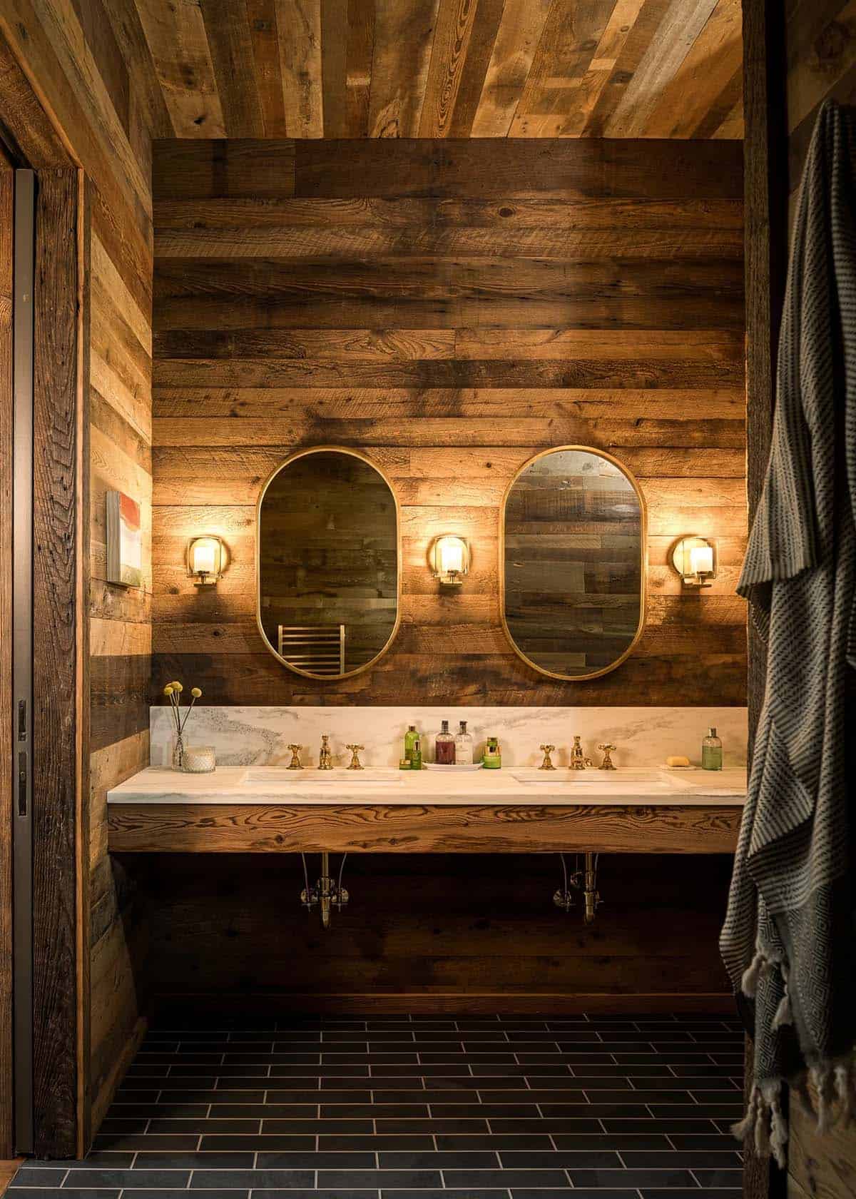 Bathroom with dual oval mirrors and marble vanity counter
