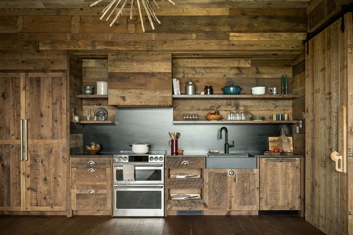 Rustic kitchen with open wood shelving and stainless range