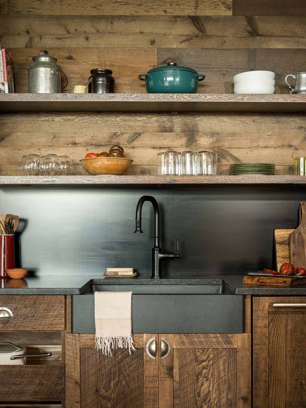 Kitchen sink area with black faucet and open shelving