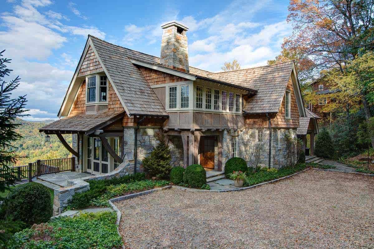 Shingle-style stone cottage with mountain views and gravel motor court