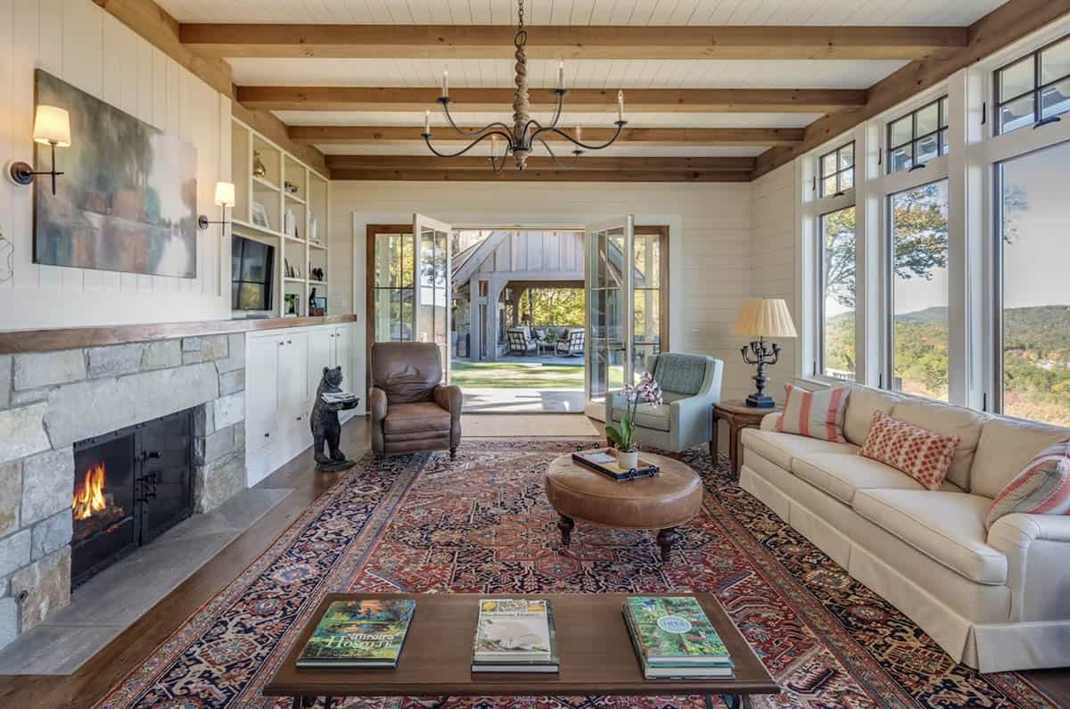 Living room with stone fireplace and French doors to patio