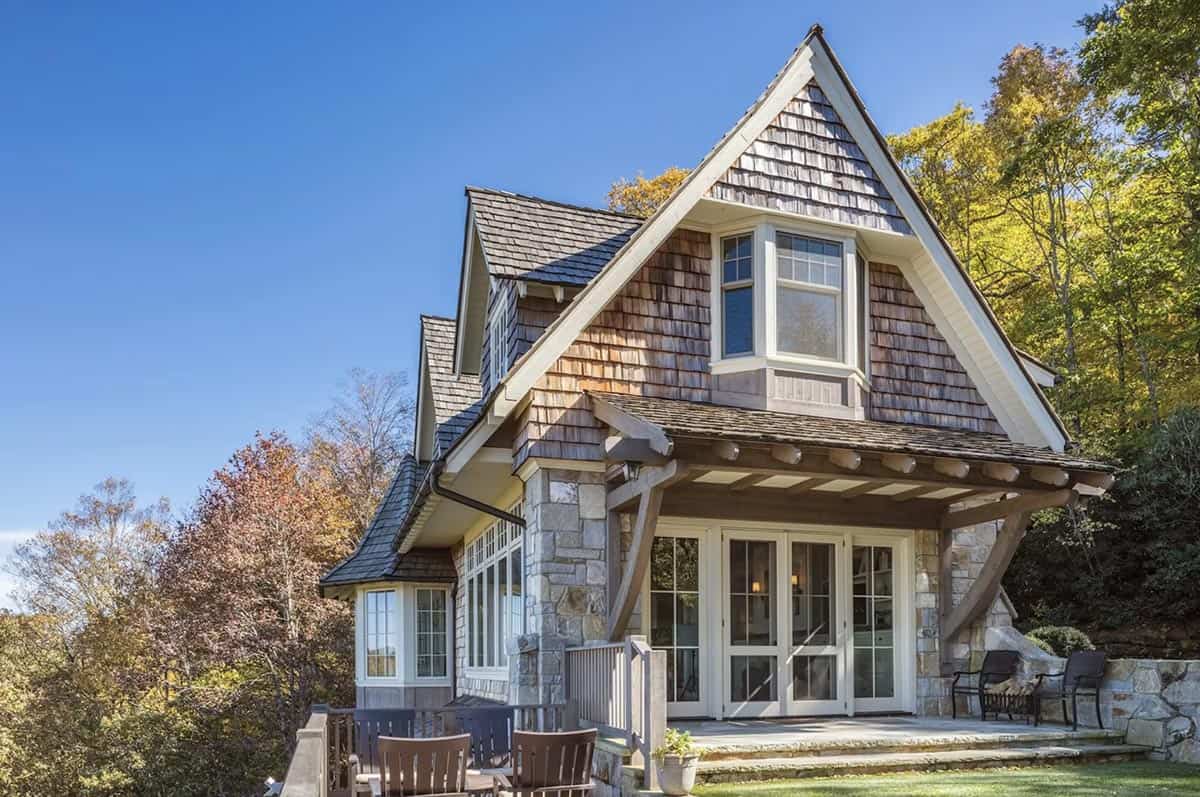 Shingled cottage facade with stone base and covered timber entry