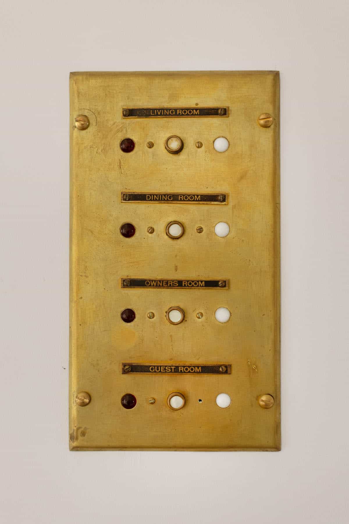 Vintage brass room call panel with labeled buttons