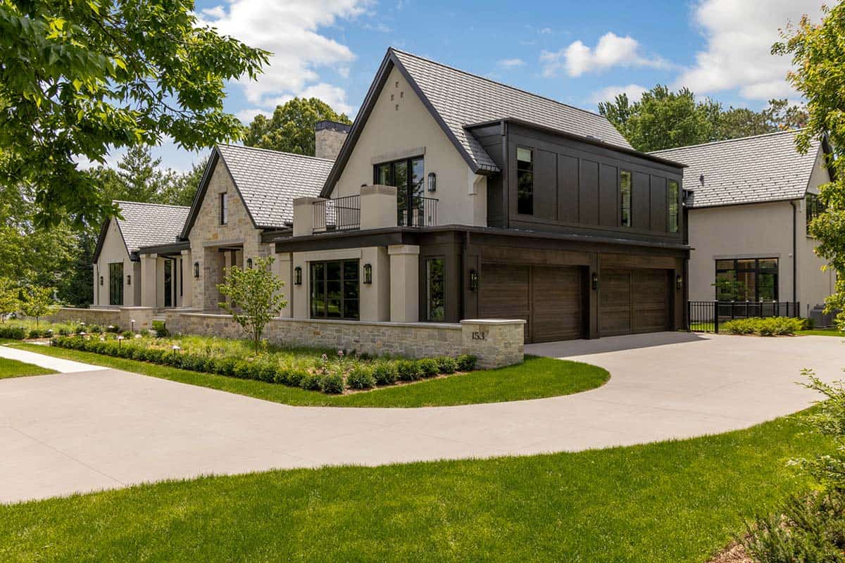 Transitional stone and stucco exterior with dark wood garage doors