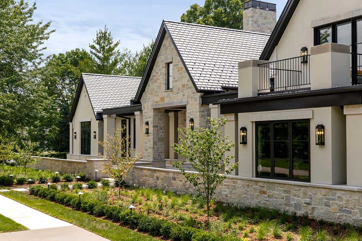 Stone gabled facade with dark trim and covered entry walkway