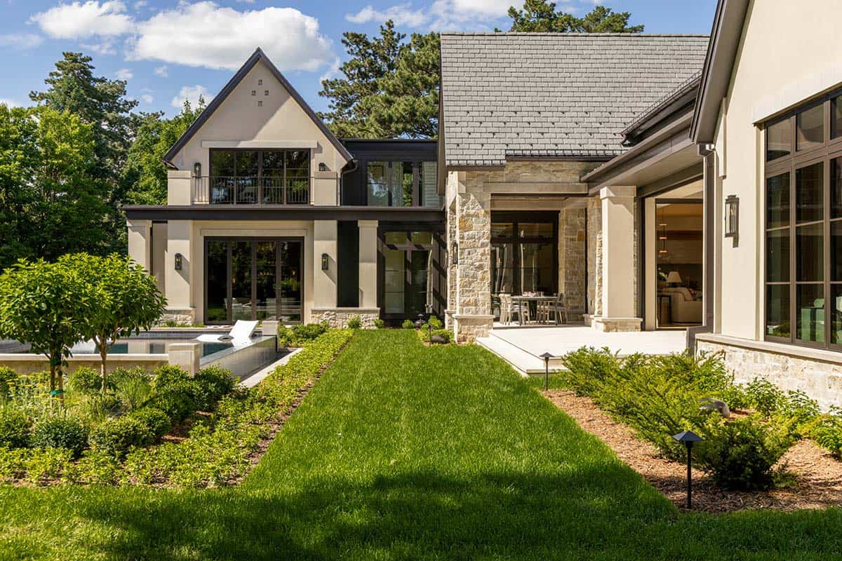 Side yard view of pool, covered patio, and glass-walled addition