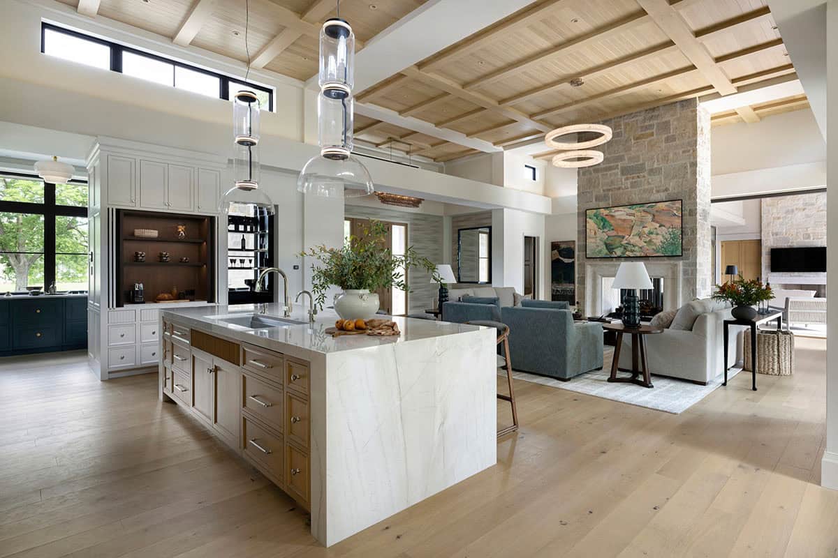 Open kitchen and living area beneath coffered wood ceiling