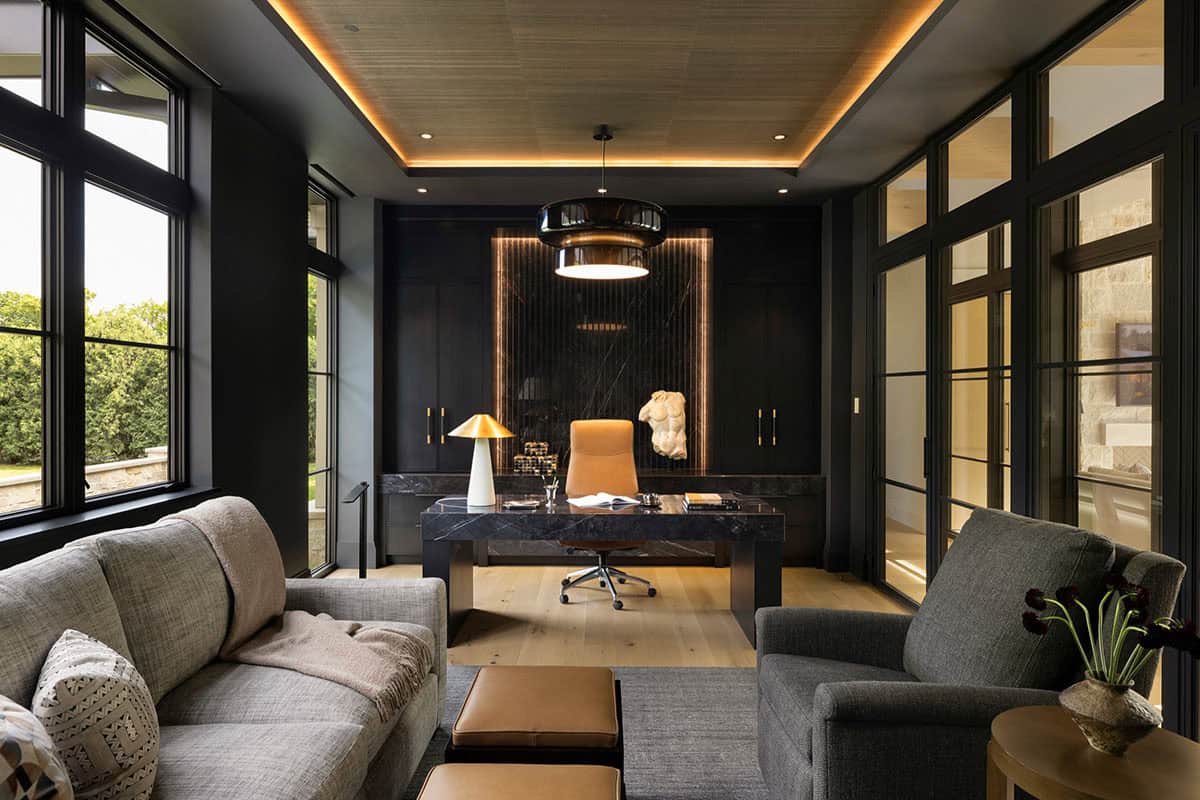 Home office with black marble desk and leather chair
