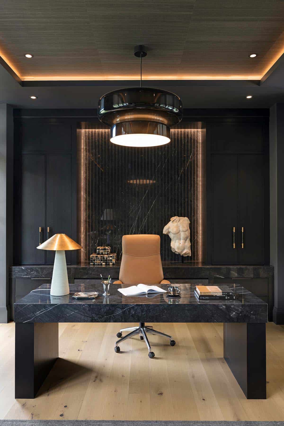 Home office desk with sculptural table lamp and stone bust