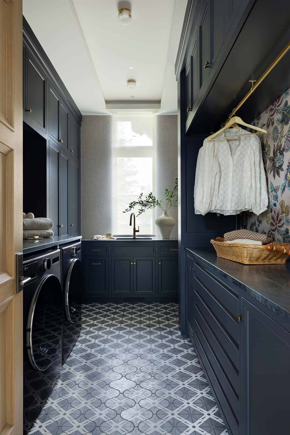 Navy laundry room with patterned tile floor and floral wallpaper
