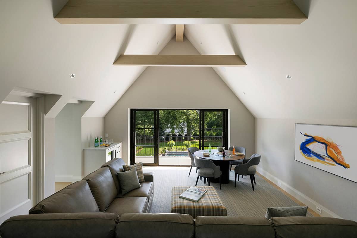 Bonus room with vaulted beams opening to balcony and pool